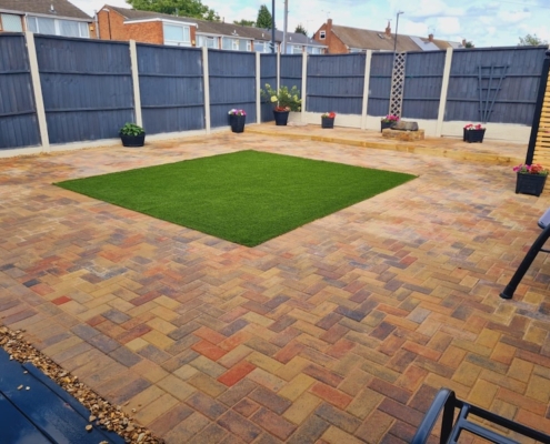 large patio with artificial grass completed