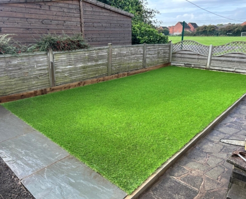 large patio and artificial grass landscaping project completed in Swadlincote by Grasshopper Landscapes