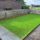 large patio and artificial grass landscaping project completed in Swadlincote by Grasshopper Landscapes
